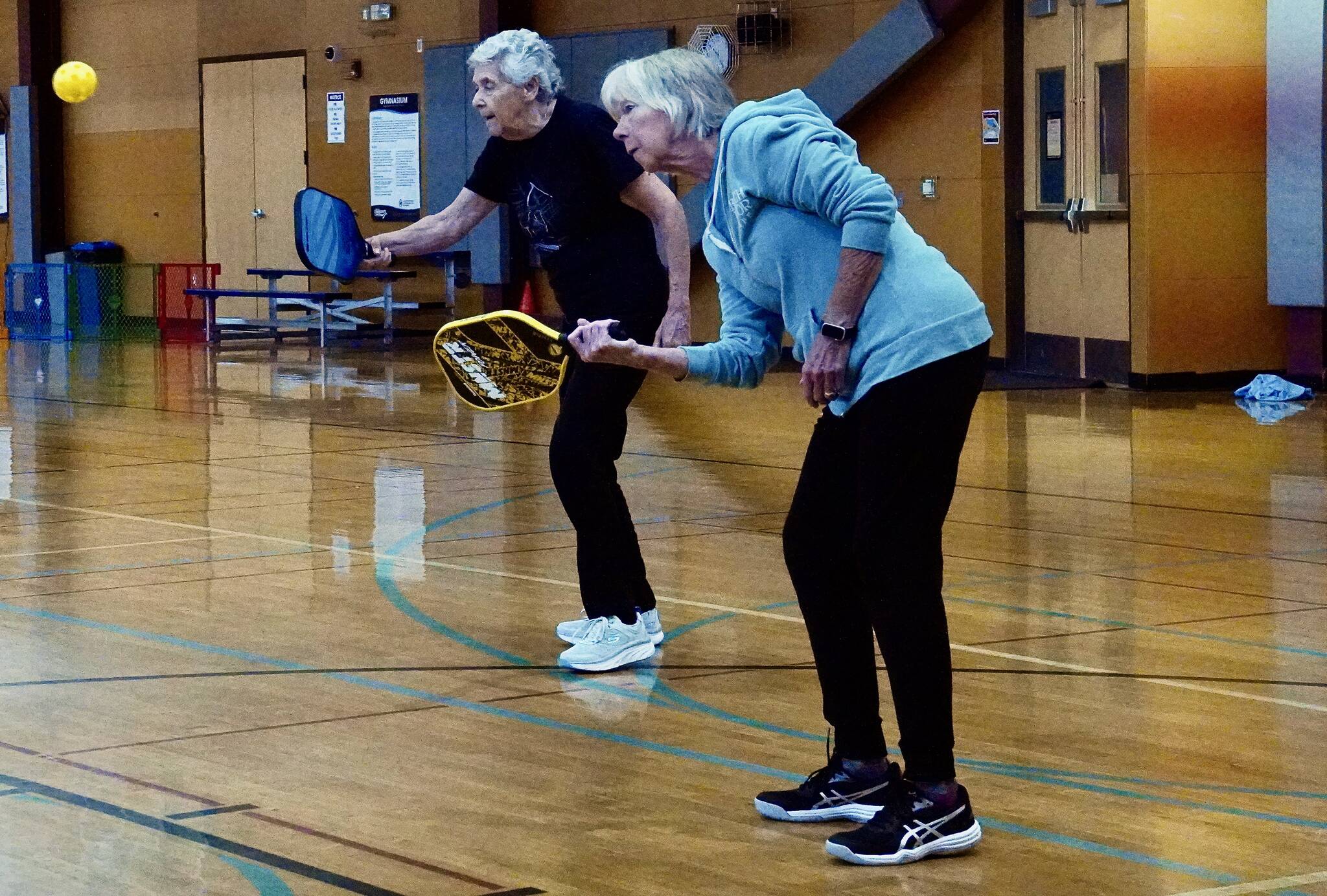 Annette Petrovich and Linda Whipple play pickleball at the Federal Way Community Center. Photo by Joshua Solorzano/The Mirror