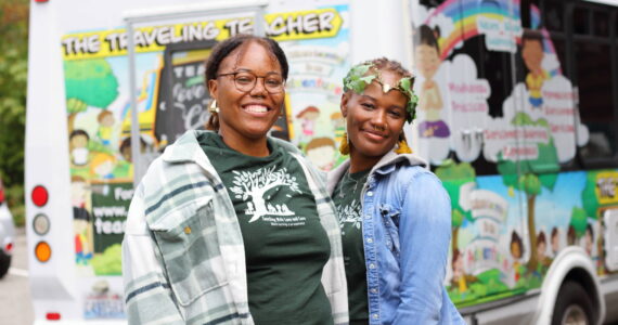Asiyah Davis and Catrice Dennis in front of their mobile classroom: a bus painted with colorful and positive illustrations. Photos by Keelin Everly-Lang / the Mirror