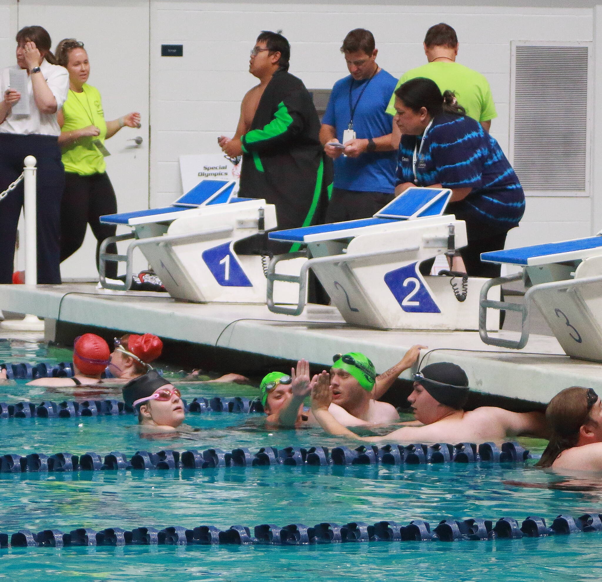 Special Olympics athletes high-five each other after a swim relay race at the 2025 Spring Games at the Weyerhaeuser King County Aquatic Center in Federal Way. The aquatic center is among recreational facilities and parks across the region that would receive upgrades with the passage of the King County Parks Levy on the Aug. 5 primary ballot. (File photo)