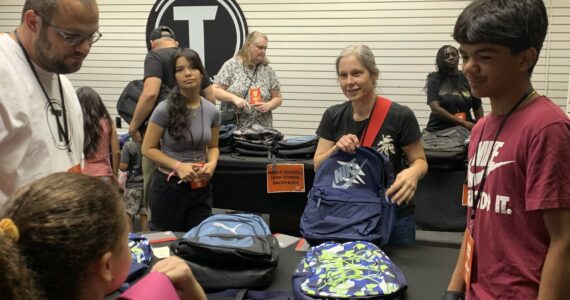 The Table gives out free backpacks at last year’s Back-to-School Bash. Photo provided by the Table.
