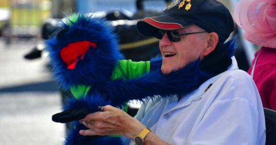 Bob Darrigan with a puppet at the Federal Way Farmers Market. Photo by Bruce Honda