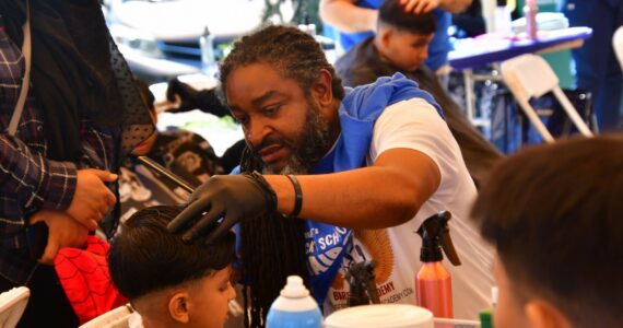 Lamont Styles offers free haircuts at the annual Back 2 School Free Haircuts event on Aug. 22. Photos by Bruce Honda