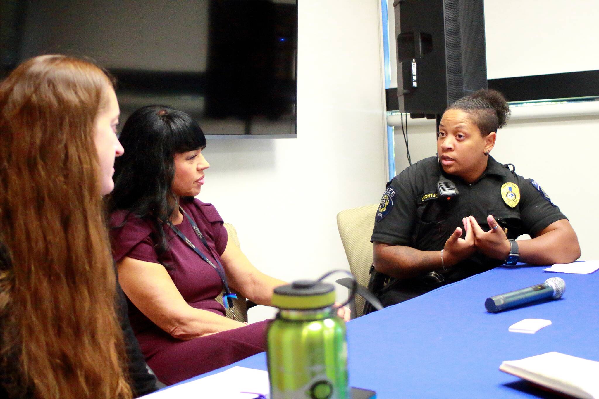 Jessica Rosado and Teri Hardy from Valley Cities discuss suicide prevention strategies in Federal Way with police officer Sarah Montjoy after the quarterly coffee chat on Sept. 17. Photo by Keelin Everly-Lang/the Mirror