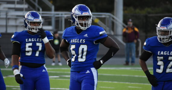 Kevin Ramsey (50), Michal Trumbo (57) and Jeremiah Harrison-Overton (52) look for the call on defense. Ben Ray / The Mirror