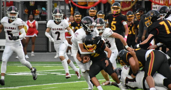 Kentlake defense wraps up Mabin Guillen. Nathan Hyun / The Mirror