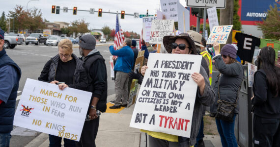 A protester in Federal Way holds a sign stating that “a president who turns the military on their own citizens is not a leader but a tyrant,” referencing the deployment of National Guard troops in several U.S. cities this year. Photo by Rachel Jones