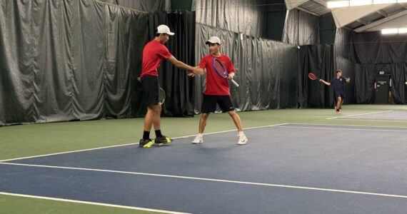 Raiders’ Vincent Pham and Dante Pham high five after point. Photo by Nathan Hyun