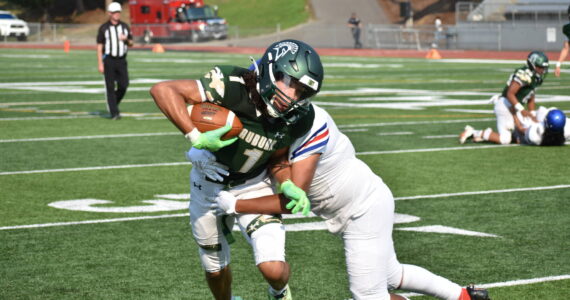 Auburn wide-out Lucas Whitehall-Gilkes takes a hit against the Royals. Ben Ray / Sound Publishing