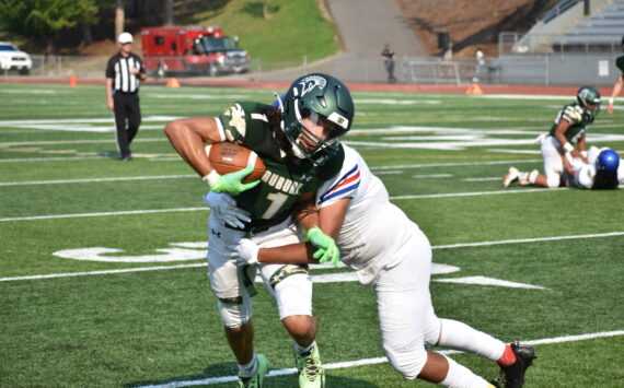Auburn wide-out Lucas Whitehall-Gilkes takes a hit against the Royals. Ben Ray / Sound Publishing