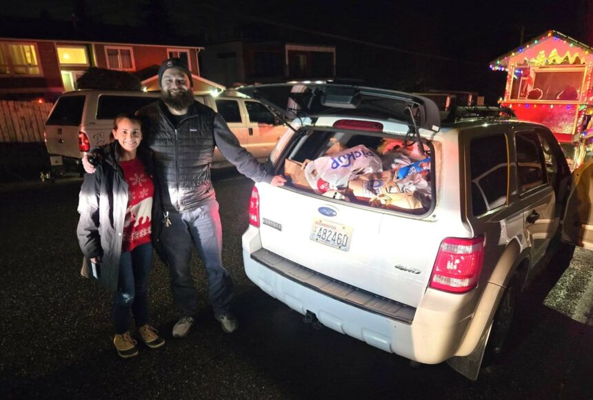 <p>Community members donating food during the Santa Parade and food drive. Courtesy photo.</p>