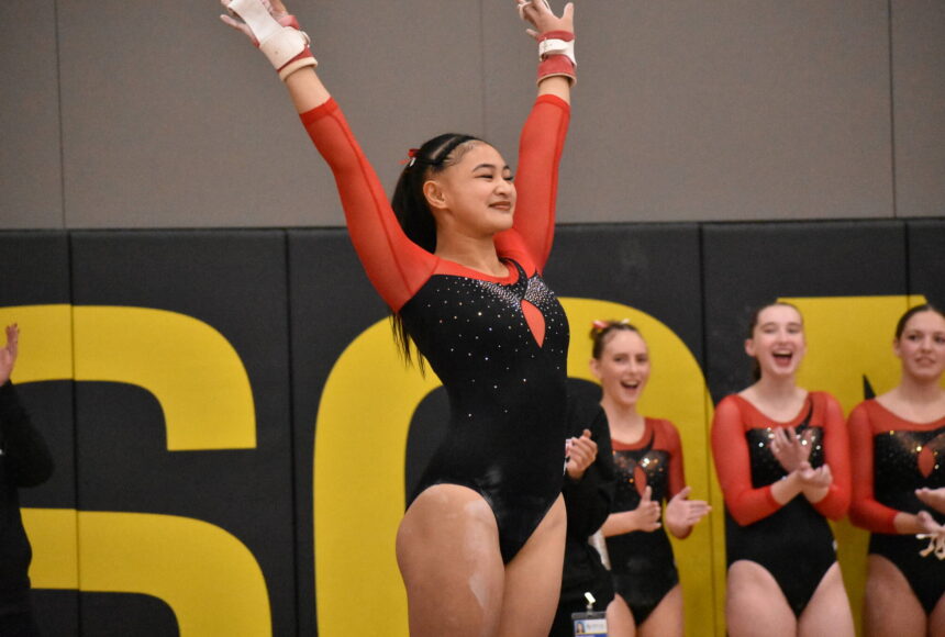 <p>Rylee Cabang salutes after her bar routine. Ben Ray / The Mirror</p>