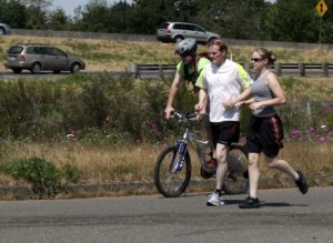 School board member Ed Barney ran the Seattle to Portland Bicycle Classic route this past week to raise money for Federal Way's Elementary Track program. Here he is near Centralia with his son Mike and daughter Kim.
