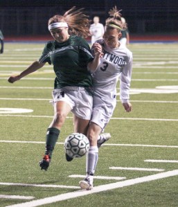 Beamer senior Mackenzie Hickel battles for the ball last week in a match against Kentwood. Hickel is one of 10 seniors on the Titans' roster. Beamer is making its second appearance in the state girls soccer tournament.