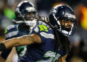 Seattle cornerback Richard Sherman celebrates after his tip in the final seconds of the fourth quarter prevented a San Francisco 49er touchdown in the NFC Championship at CenturyLink Field in Seattle.