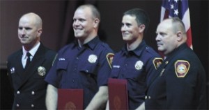 Chris Boone and Tyler Wilkins-Haigh pose with their diplomas at the recruit school graduation ceremony.