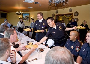 Federal Way Police Chief Brian Wilson and Deputy Chief Andy Hwang bring new meaning to the term public servants at the Farmers Market Chili Cook-Off awards banquet – where losers served the winners and everybody enjoyed the festivities.