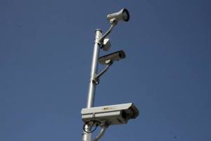 The intersection of South 320th Street and Pacific Highway South features photo enforcement cameras for red light violations.