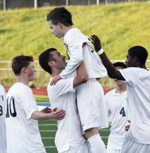 Todd Beamer junior Ike Crook is held up after scoring a goal last season for the Titans. Crook is currently playing for the Sounders FC Academy team.