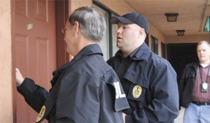 Federal Way police officers James Widick and Brian Bassage and community corrections officer Justin Childers attempt to confirm the registered Federal Way address of a sex offender. Federal Way police and the Department of Corrections teamed up Oct. 31 to check on 15 offenders currently monitored by the DOC.