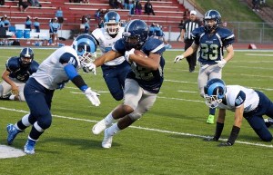 Andrew Tofaeono runs through tacklers against Mount Rainier on Friday
