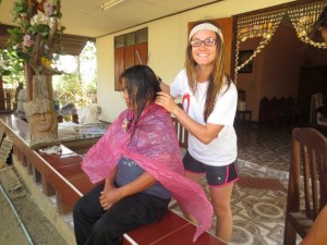 Young Careerist Jessica Dahl cuts a woman in need’s hair during her trip traveling across the world. Dahl has traveled to 19 countries as well as to Cambodia to help with the Justice and Soul Foundation.
