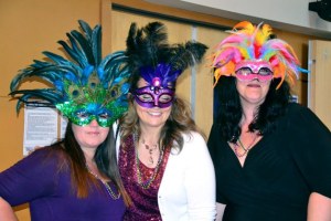 Federal Way employees show off their Mardi Gras attire during the Multi-Service Center's annual fundraiser on Saturday at the Multi-Service Center.