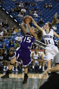Issaquah's Taryn Holmes is blocked by Federal Way's Jacqie Evenson Thursday night. Federal Way blocked nine Issaquah shots and cruised to a 54-38 quarterfinal win.