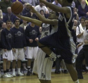 Beamer sophomore Napa Nefi goes in for two of his team-high 28 points during Friday's West Central District win over Bellarmine Prep at Auburn High School. The win qualified the Titans for their first-ever Class 4A State Boys Basketball Tournament
