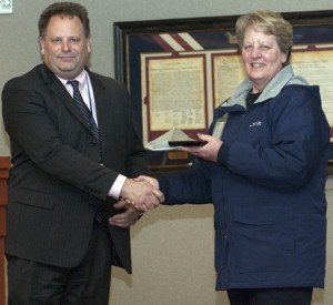 Police Chief Brian Wilson honors volunteer Lottie Kinney at the March 20 meeting of the Federal Way City Council. Kinney
