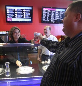 Federal Way police spokeswoman Cathy Schrock serves Sub Zero ice cream to South King Fire and Rescue's Kevin Crossen.