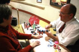 City Manager Neal Beets paints the nails of Tamara Fix