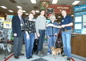 Petco manager Michael Jankowski hands over two checks totaling approximately $5
