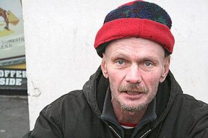 A homeless man in Federal Way sits near a building.