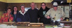 Reach Out volunteers prepare food to serve to homeless men staying at the shelter this past winter. Local churches and volunteers will continue to play an essential role in helping the men next winter when the shelter reopens under new management by the Catholic Community Services.