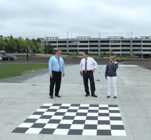 Mayor Jim Ferrell (center) speaks with city staff on site of the new Town Square Park