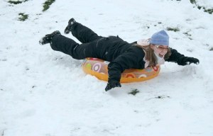 Federal Way resident Anna Reusser slides on an intertube down a snowy hill at Celebration Park on Sunday morning.