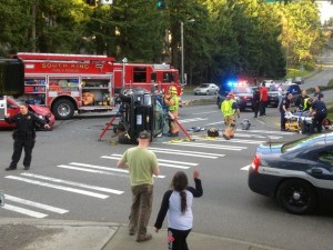 South King Fire and Rescue firefighters extricate trapped passengers from a Chevy Trailblazer that flipped on its side on Friday evening in Federal Way.