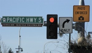 A sign alerts motorists to photo enforcement at the corner of Pacific Highway South and South 320th Street in Federal Way.