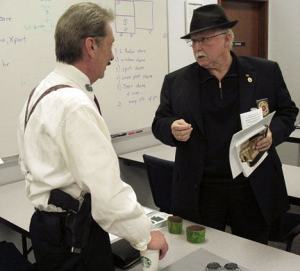 Gun advocate Jim Beal talks with South King Fire Commissioner James Fossos at last Thursday’s special meeting. The commissioners changed a policy to allow the public to carry guns on district property.