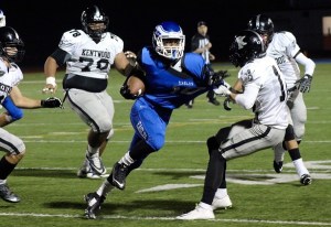 Federal Way's Chris Williams is brought down by Sam Kramer during Kentwood's 16-13 win on Thursday