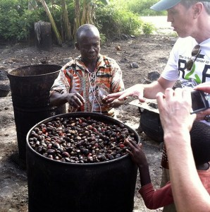 Decatur High School Principal David Brower watches as a villager processes palm oil in Ghana during a recent trip in November.
