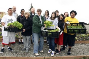Volunteers show off their organic bounty from the Truman Community Garden in this file photo.