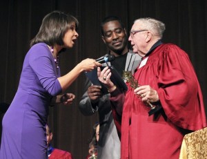 Q13 Fox News anchor Angela King and Federal Way author Nandell Palmer present an I Celebrate You award to Bob 'Coach' Roach.