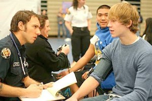 A student goes through the heart screening process at a Nick of Time Foundation event. An undetected heart condition is the leading cause of death in young athletes on the playing field.