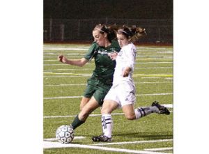 Beamer’s Linsey Richou (left) battles with Kentwood’s Laura Moore for the ball during Wednesday’s SPSL girls soccer title match at Federal Way Memorial Stadium. Kentwood won the game