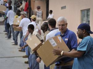World Vision president Rich Stearns (second from right) joins a chain of volunteers unloading World Vision donated medical supplies on Jan. 19 to Hope Hospital in Port au Prince