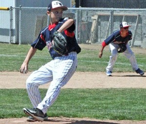 Nate Clow winds up for a pitch while Abi Gonzalez readies for the play in recent action for the Federal Way National Little League Majors All-Stars.