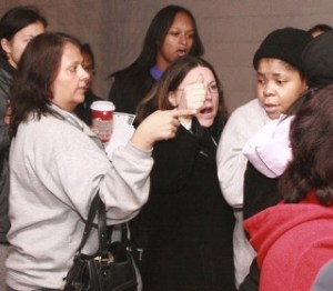 Shoppers scold a woman who cut in line as Wal-Mart opened its doors at 5 a.m. Friday in Federal Way.