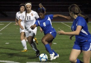 Federal Way's Julian Johnson takes control of the ball near Jefferson's Jasmine Pleasants.