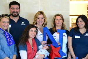 Assistance League of South Puget Sound volunteers pose for a photo in front of the Kohl's store in Federal Way last Saturday.